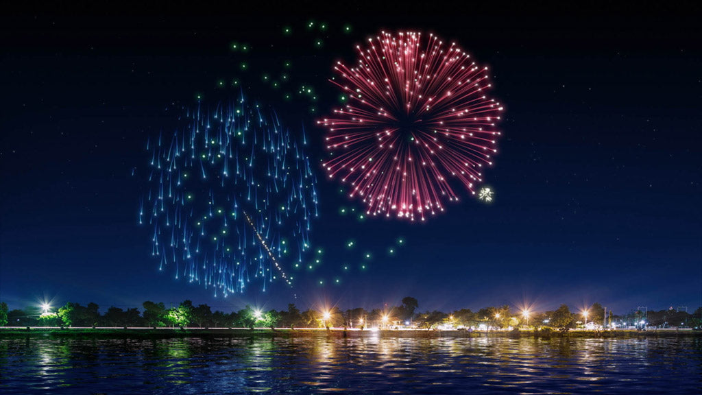 digital fireworks exploding over water